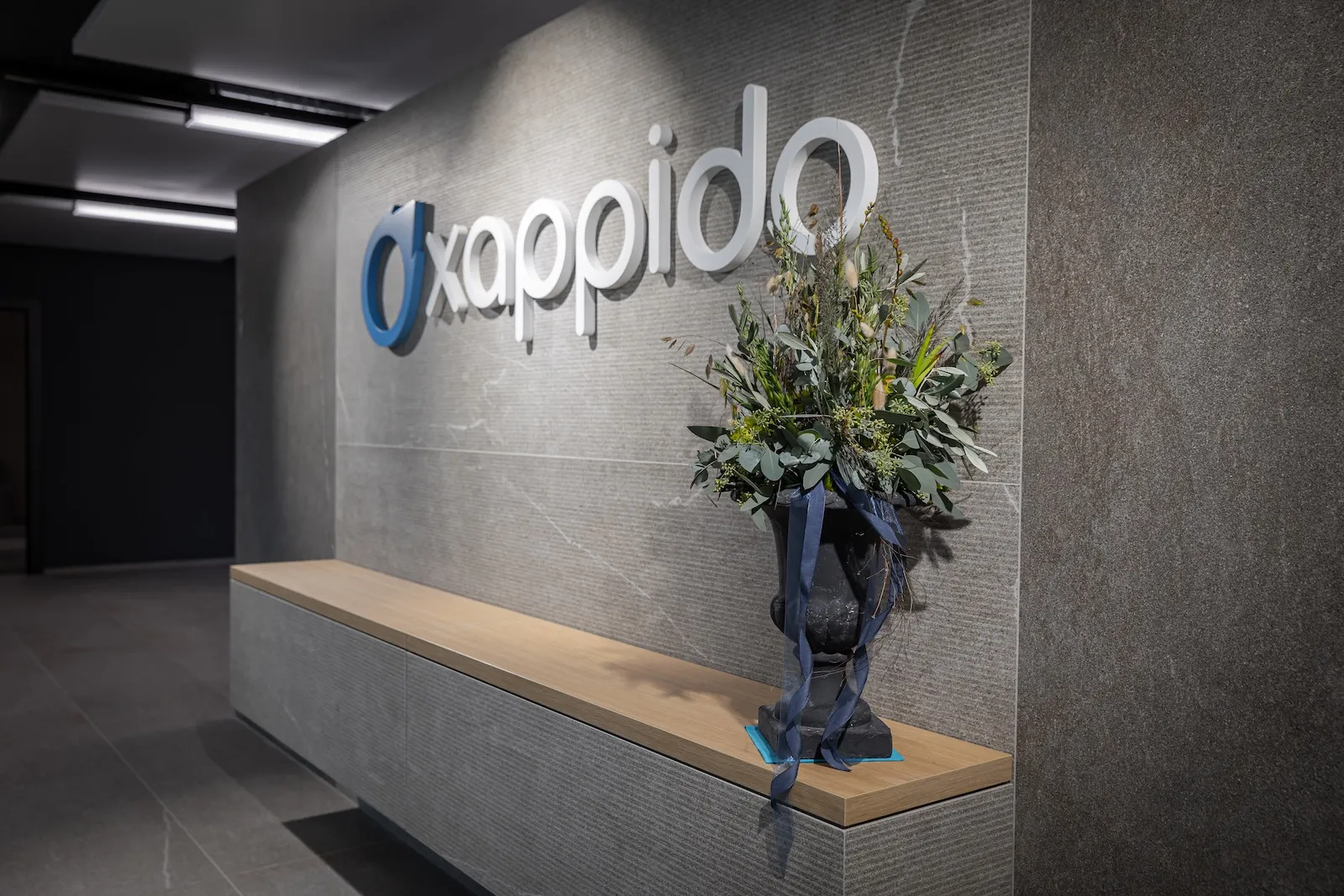 Reception at the xappido ag office in Sursee, with the xappido logo on the wall